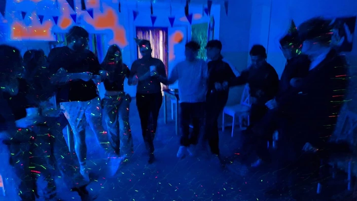 Eine Gruppe junger Menschen tanzt auf der Faschingsparty im CJD Internat Ilmenau.